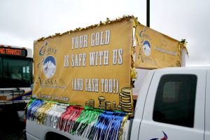 "Your Gold is Safe with Us" on a truck float.